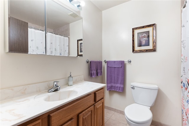 bathroom featuring toilet, vanity, and tile patterned floors