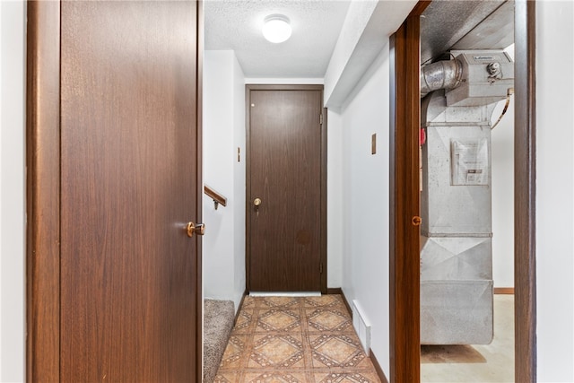 hall with a textured ceiling