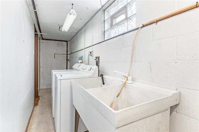 laundry room featuring washing machine and clothes dryer and sink