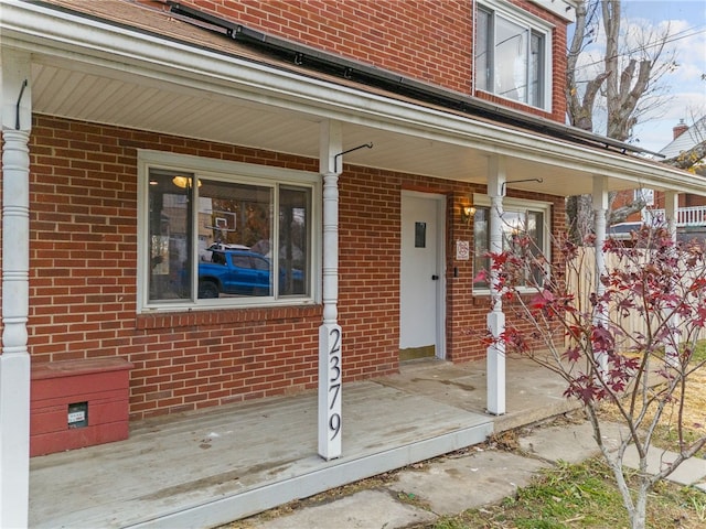 view of exterior entry featuring a porch