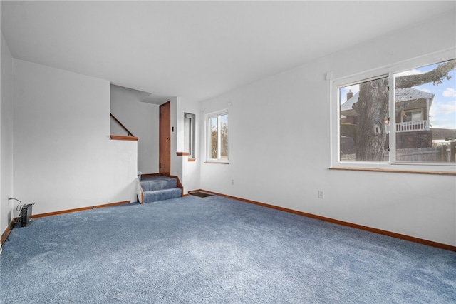 unfurnished living room featuring carpet flooring and electric panel