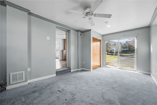 carpeted empty room with ceiling fan and crown molding