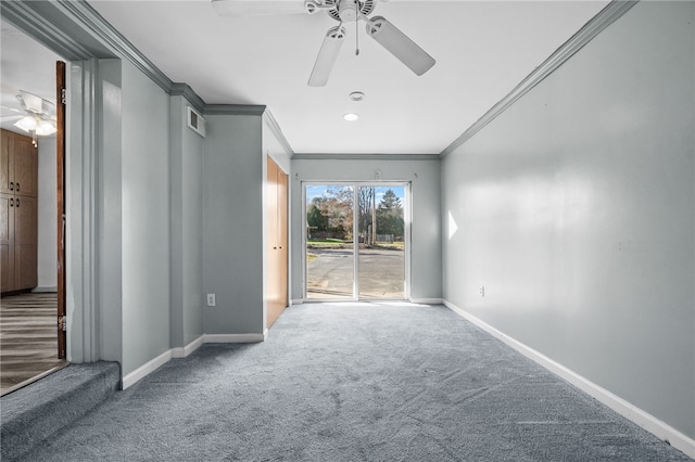 carpeted empty room with ceiling fan and crown molding