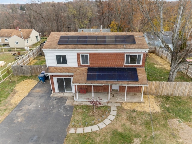 exterior space featuring solar panels and a patio area