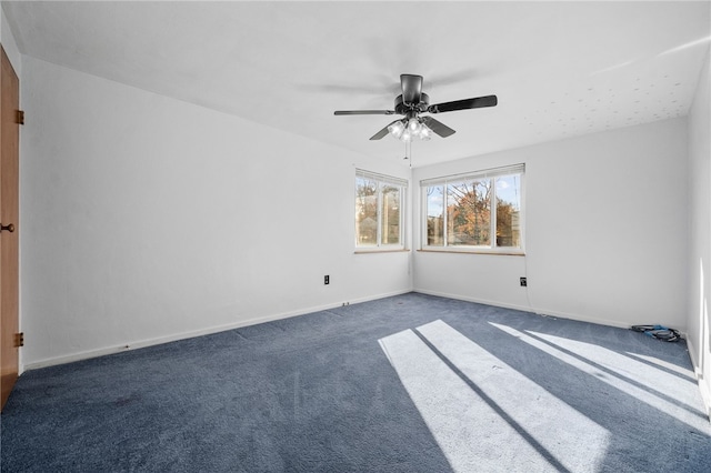 carpeted empty room featuring ceiling fan