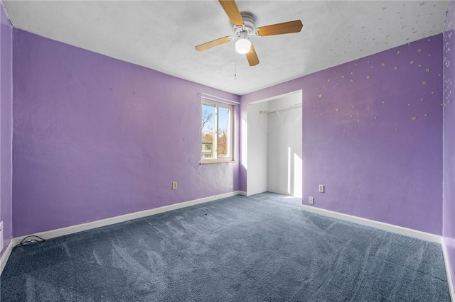 carpeted spare room featuring ceiling fan