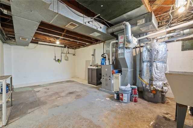 basement featuring heating unit and sink