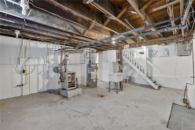 unfinished below grade area featuring stairway, water heater, a heating unit, and a sink