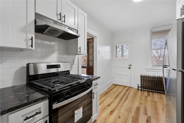 kitchen featuring tasteful backsplash, light wood-type flooring, white cabinets, and stainless steel appliances