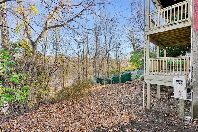 view of yard with ac unit and a balcony