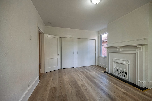 unfurnished living room with light hardwood / wood-style floors