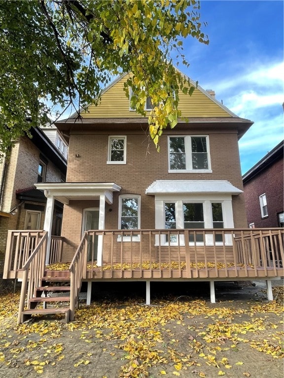 back of property featuring a wooden deck