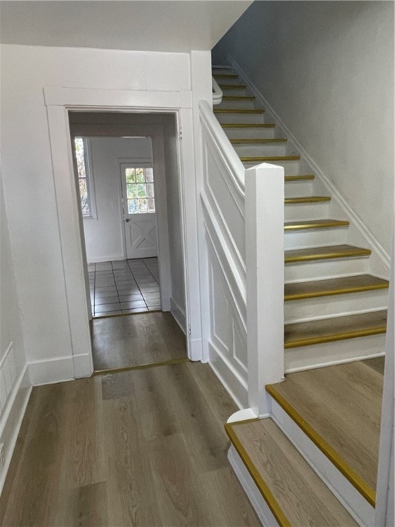 staircase with hardwood / wood-style floors