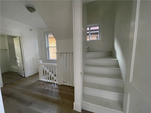 staircase with hardwood / wood-style floors and plenty of natural light