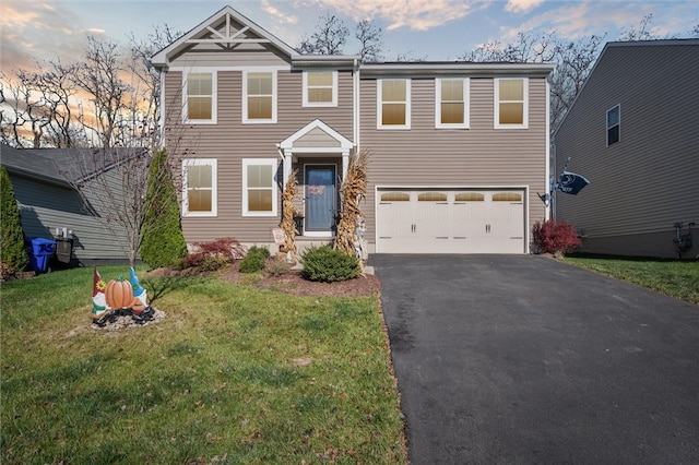 view of front of property featuring a garage and a yard