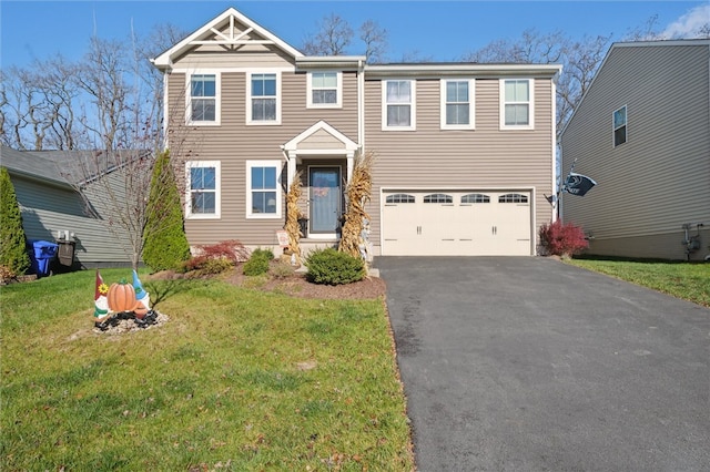 view of front of property featuring a garage and a front lawn