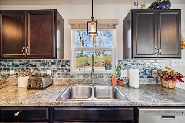 kitchen with dishwasher, tasteful backsplash, sink, and dark brown cabinets