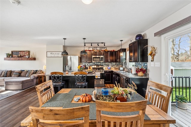 dining area with hardwood / wood-style flooring and sink