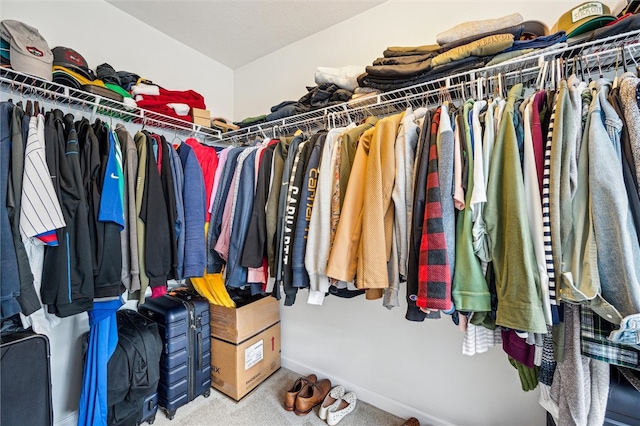 walk in closet featuring carpet