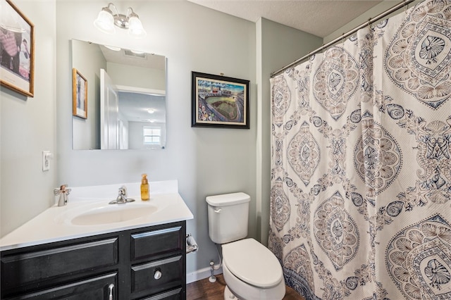 bathroom featuring wood-type flooring, vanity, a textured ceiling, toilet, and a chandelier