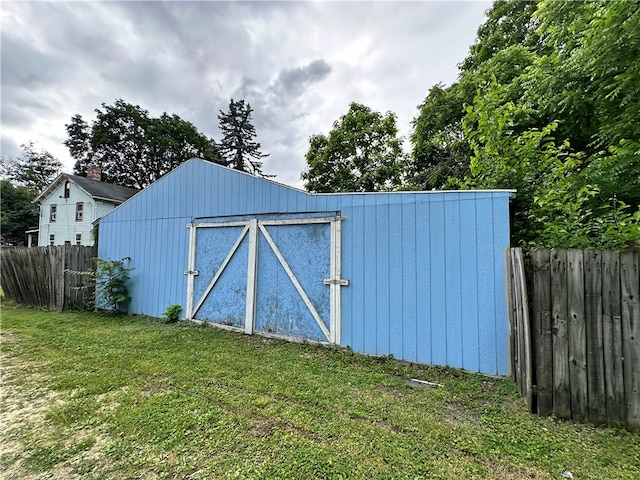 view of outbuilding with a lawn