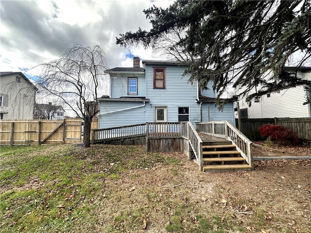 rear view of house featuring a wooden deck