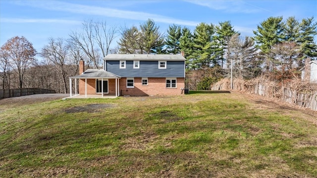 back of property with a patio and a yard