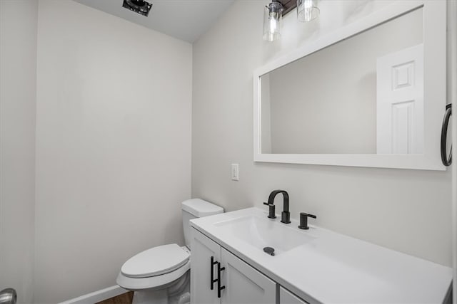 bathroom featuring toilet and vanity