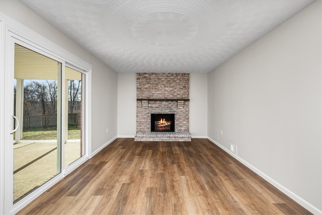 unfurnished living room featuring a fireplace and hardwood / wood-style flooring