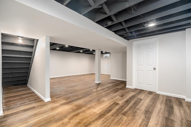 basement with hardwood / wood-style flooring