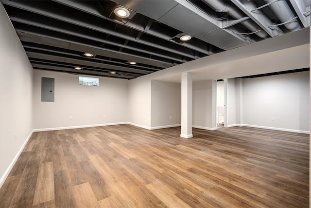 basement featuring electric panel and hardwood / wood-style floors