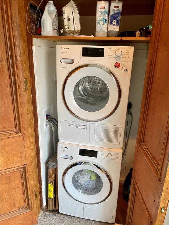 laundry area with laundry area and stacked washer / dryer