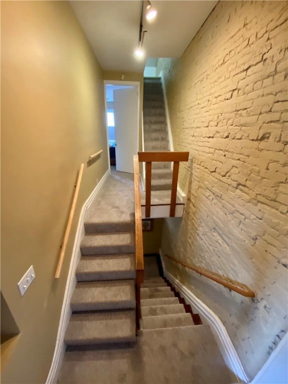 stairs with rail lighting and baseboards