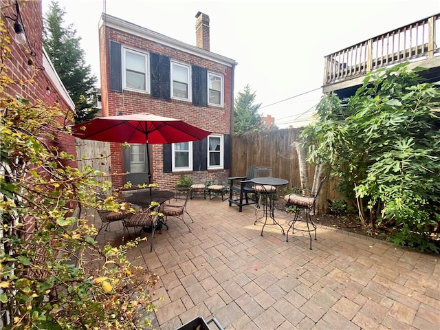 view of patio with outdoor dining space and fence