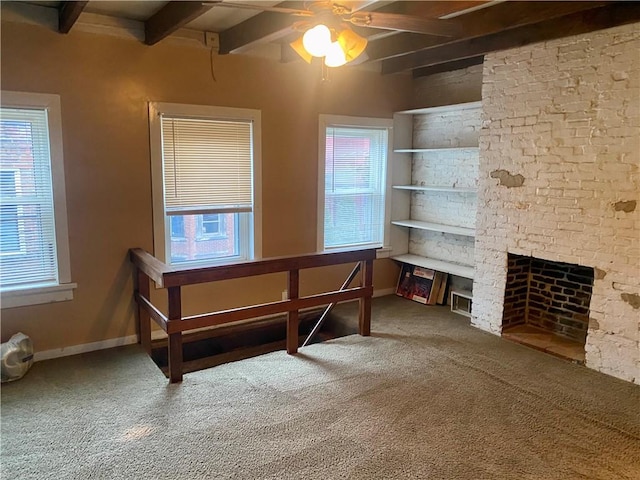 bedroom with a brick fireplace, multiple windows, beamed ceiling, and baseboards