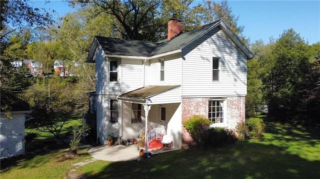 rear view of house with a lawn