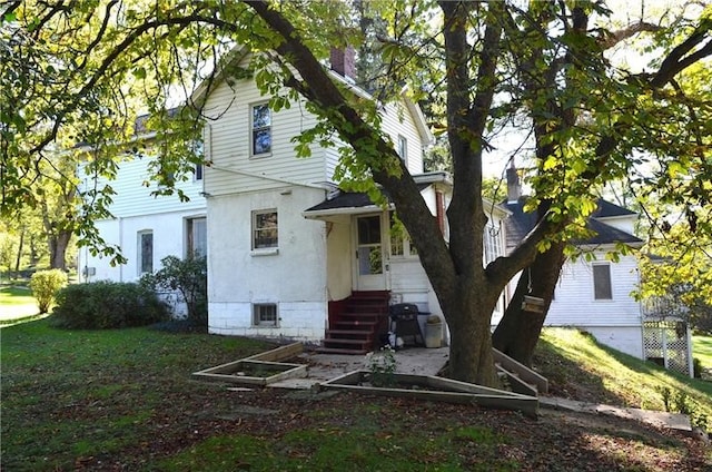 rear view of property with a yard