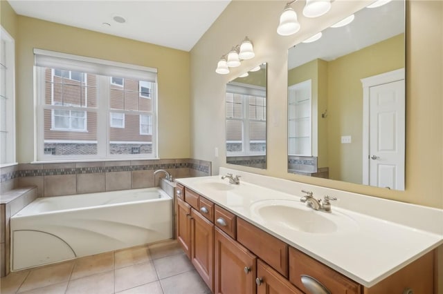 full bathroom with tile patterned flooring, a sink, a bath, and double vanity