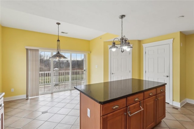 kitchen featuring pendant lighting, visible vents, baseboards, and light tile patterned floors