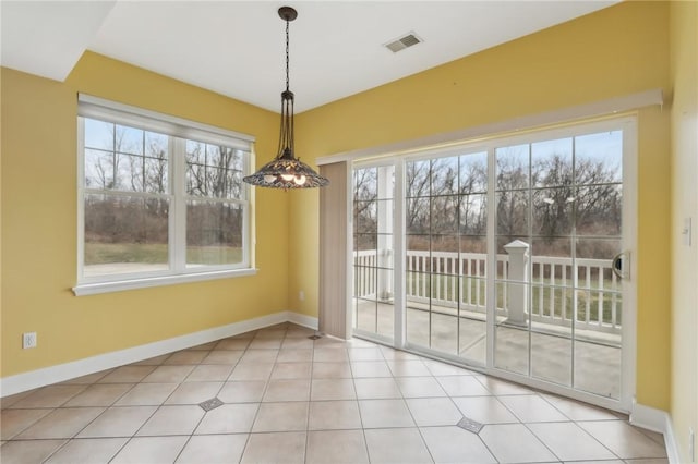 unfurnished dining area with light tile patterned floors, baseboards, and visible vents