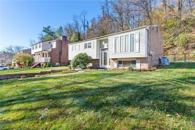 split foyer home with a front lawn