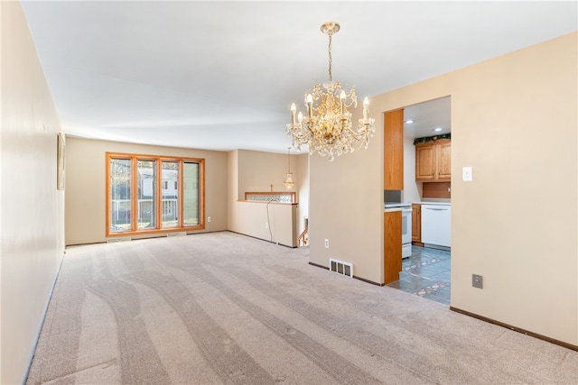 unfurnished living room with an inviting chandelier and light colored carpet