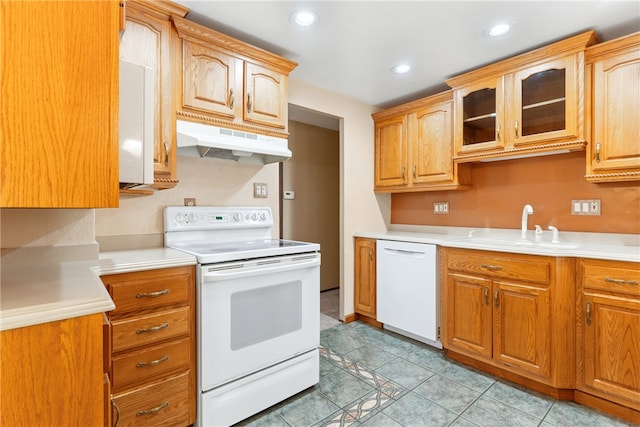 kitchen with sink, white appliances, and light tile patterned flooring