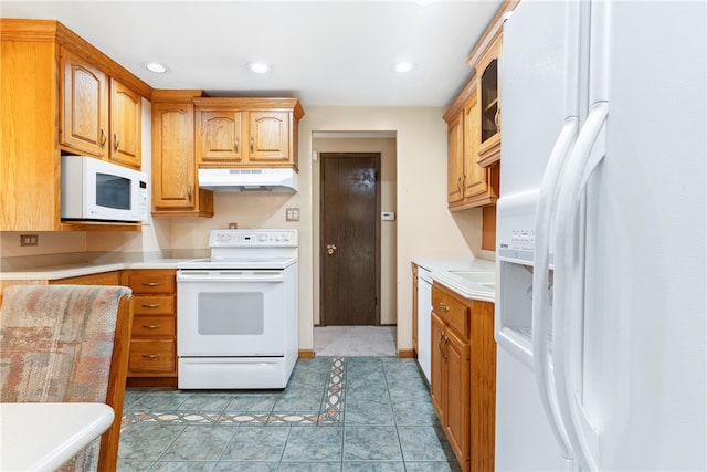 kitchen with white appliances, sink, and tile patterned floors