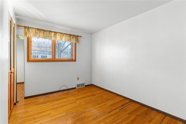 spare room featuring light hardwood / wood-style flooring