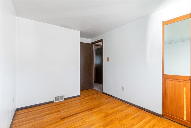 empty room with light hardwood / wood-style flooring