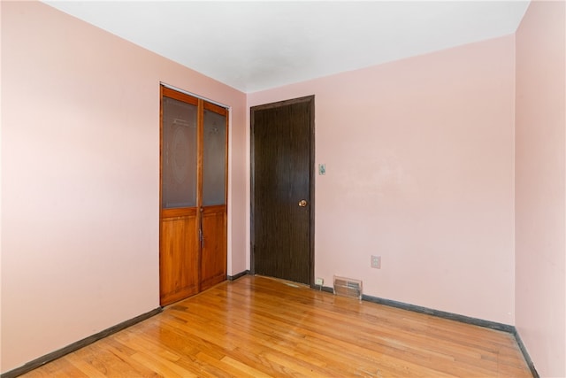 empty room with light hardwood / wood-style floors