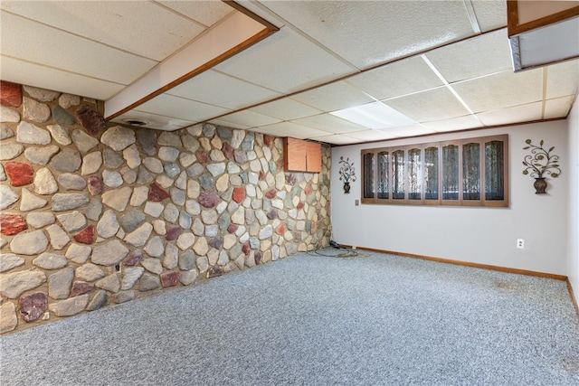 basement featuring a paneled ceiling and carpet flooring