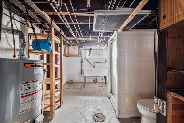 basement with gas water heater and sink