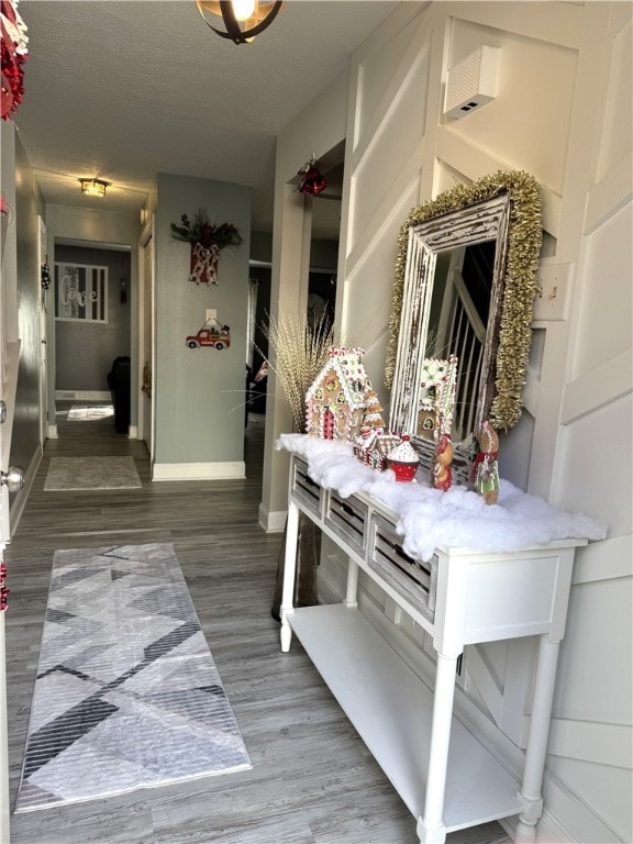 mudroom featuring a textured ceiling and dark hardwood / wood-style floors